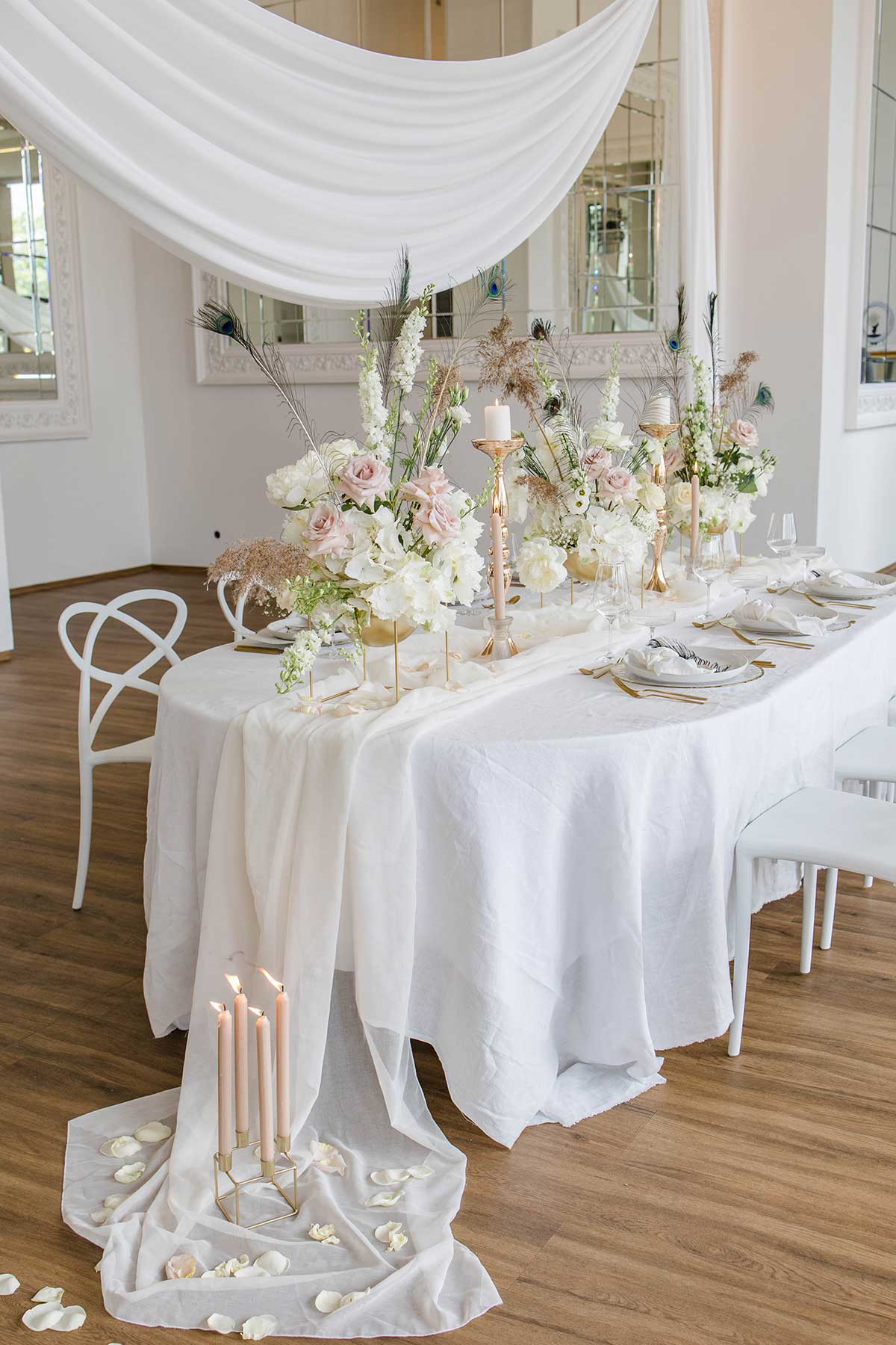 Hochzeitstisch mit Wasserfall Mitteldecke und Kerzen auf der unteren Decke